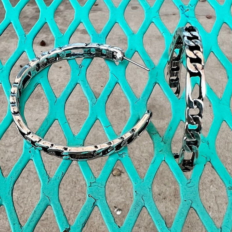 These eye-catching Chained to Hoop Earrings are perfect for those looking to showcase a bold and glamorous style. Crafted with high-quality materials, they come in two color options: silver or copper, with a delicate chain link design for an elegant finish. The 2" size is perfect for making a statement and elevating every look.