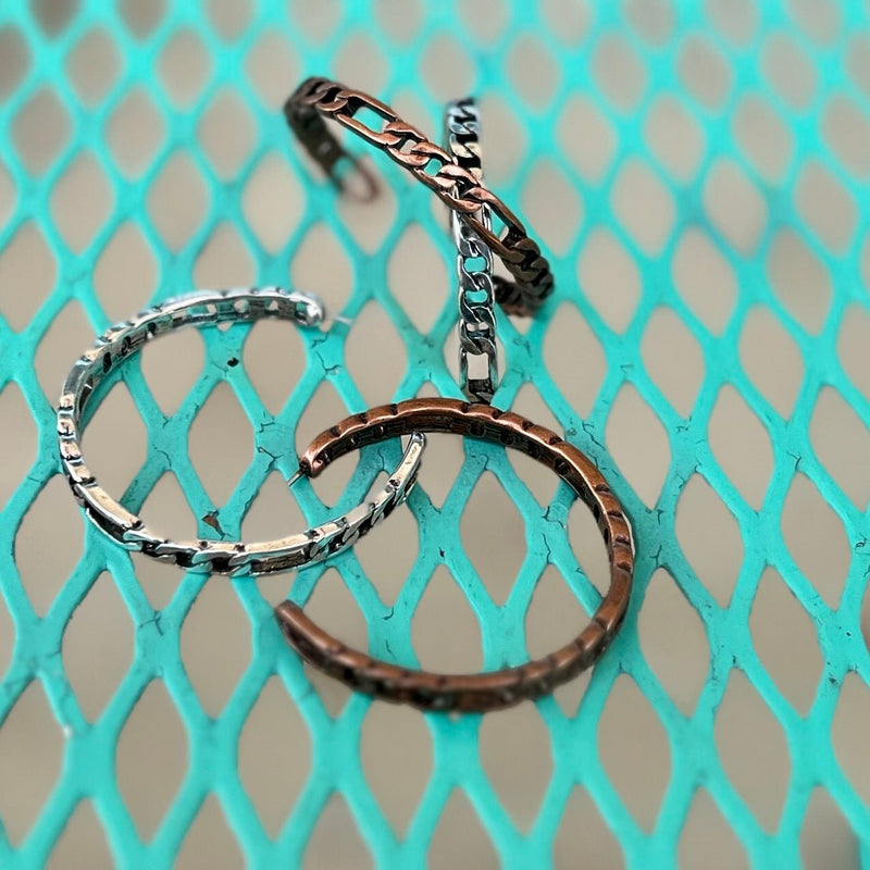 These eye-catching Chained to Hoop Earrings are perfect for those looking to showcase a bold and glamorous style. Crafted with high-quality materials, they come in two color options: silver or copper, with a delicate chain link design for an elegant finish. The 2" size is perfect for making a statement and elevating every look.