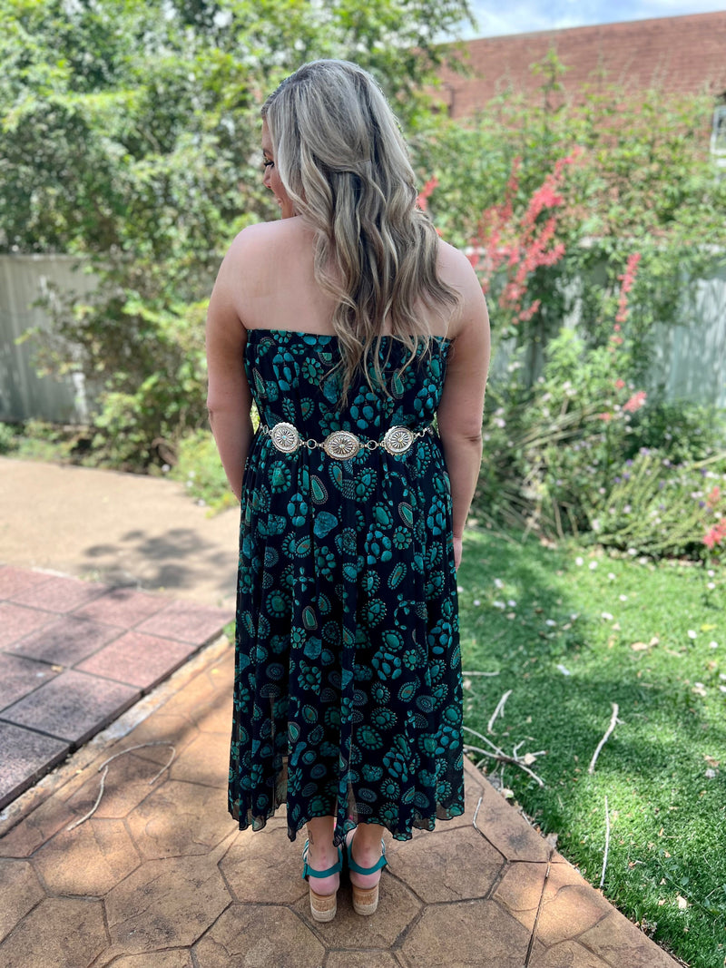 Dive into the Wild West with this Concho Kreek Maxi Skirt! Featuring vibrant turquoise squash blossoms and a black slip underneath, you can be sure to make a statement of style. Ready for a wild and adventurous day? Saddle up and get ready to ride!