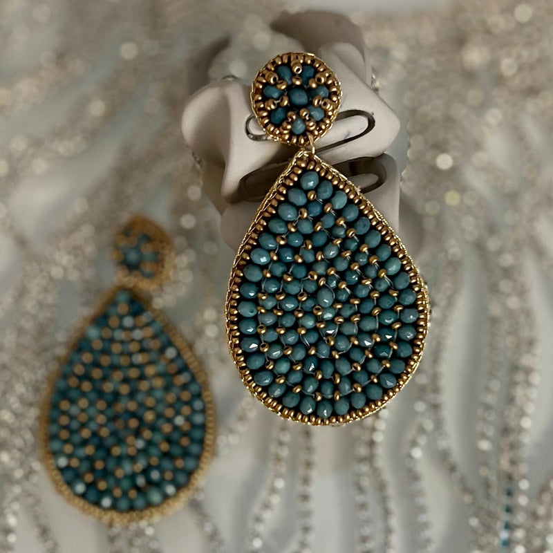 These Seed Bead Tear Earrings dazzle with intricate craftsmanship and opulence. The earrings feature a layered tear drop shape made from glass seed beads in four different colors - multi, red, black & turquoise - along with glass crystal beads. The final touches of the dangle design include a post back and a length of 3" to gracefully frame your face. Showcase your flawless style with these beautiful earrings.
