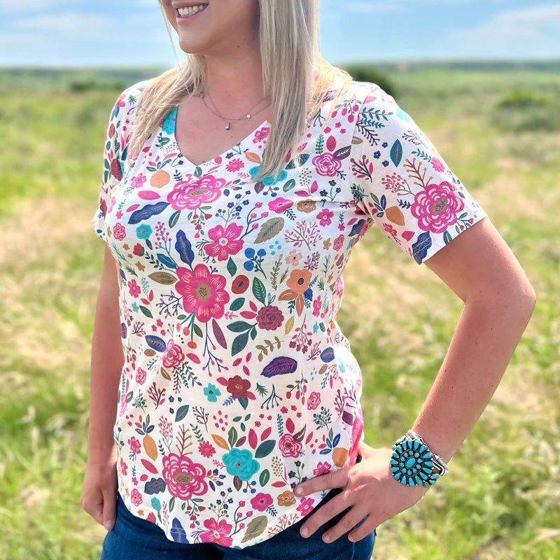 Cream v-neck with flowers. Floral top. Spring top. Women's vneck top. Women's spring outfit. Women's floral top. Women's top with flowers. Spring fashion. Spring outfit. Flowery top. Short sleeve top. Soft shirts. Comfortable shirt. Casual tops. Casual shirts. Everyday shirt. Everyday top. Small business. Woman owned. 