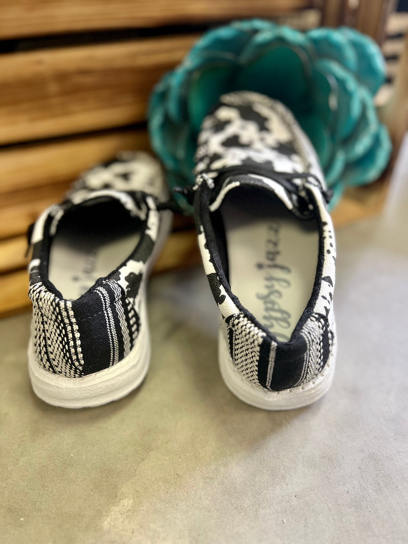Introducing the Cow in a Meadow Loafers. Gracefully crafted with a black and white cow print for a timeless look, and a black and white aztec print to add a splash of character. Slip on with ease and a comfort sole for a luxurious, relaxing fit. All together, these shoes offer a beautiful and comfortable look for any occasion.