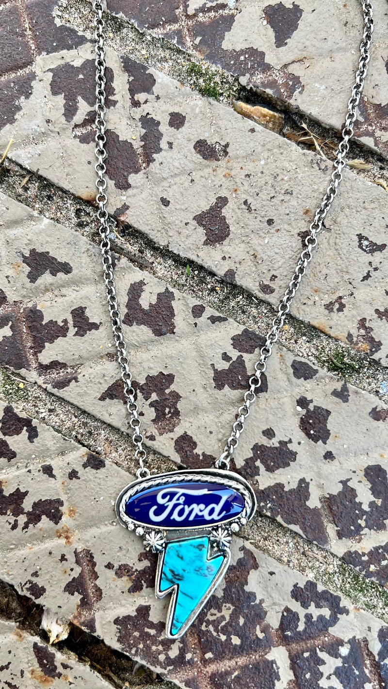 Express your love of classic American brands with this Ford Necklace! Featuring a western-style concho in a high-polish silver finish, plus a thunderbolt and Ford logo for the perfect combination of style and spirit. 15" silver chain with a 3" adjustable lobster clasp
