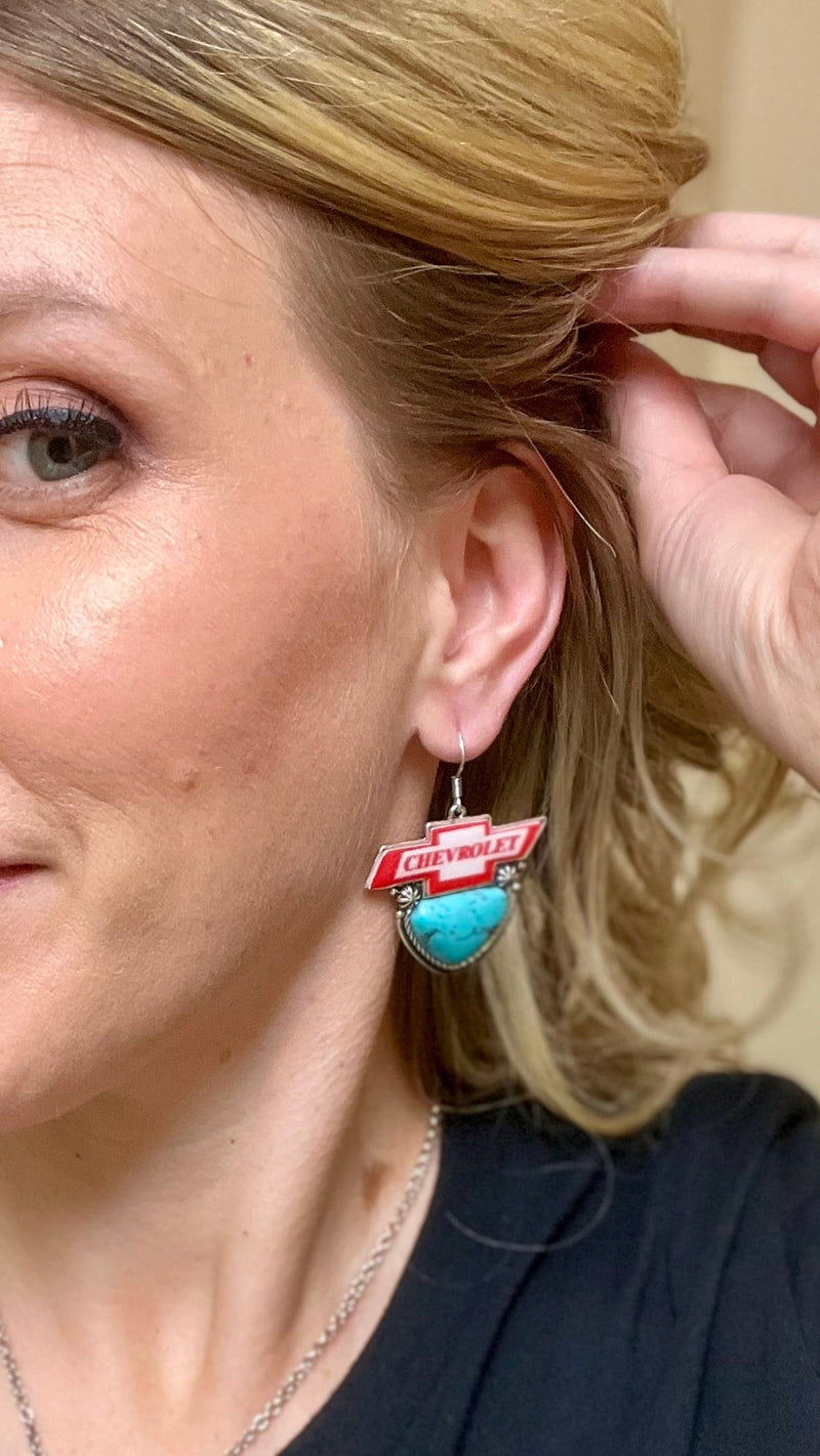 Look no further for the perfect way to merge your love of cars and style - these Chevrolet Earrings are the perfect combo! Featuring high polished silver and western concho style with the iconic Chevrolet logo, these dangly earrings will be sure to rev up any look! Vroom, vroom!