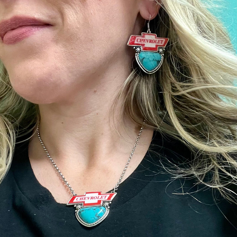 Express your love of classic American brands with this Chevrolet Necklace! Featuring a western-style concho in a high-polish silver finish, plus a turquoise stone and Chevrolet logo for the perfect combination of style and spirit. 15" silver chain with a 3" adjustable lobster clasp  **Matching Earrings sold seperately**