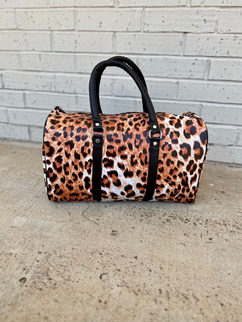 Explore the wild side with these eye-catching Wild Journey Travel Bags! The perfect carry-on sized handbag, they boast plenty of faux animal leather and a stylish animal print. Go on a spontaneous getaway with your new favorite travel companion! (No need to worry about forgetting the essentials– these bags have you covered!)  17"L X 9"W X 10"H