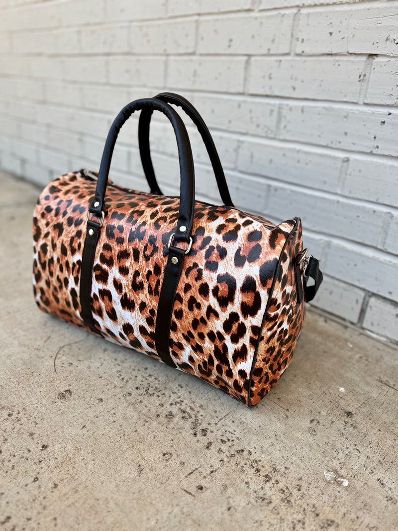 Explore the wild side with these eye-catching Wild Journey Travel Bags! The perfect carry-on sized handbag, they boast plenty of faux animal leather and a stylish animal print. Go on a spontaneous getaway with your new favorite travel companion! (No need to worry about forgetting the essentials– these bags have you covered!)  17"L X 9"W X 10"H