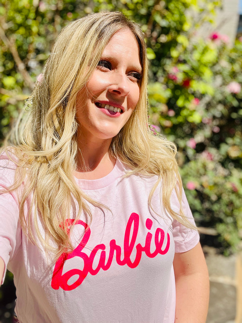 This Pink Barbie Graphic Tee will have you looking and feeling like a million bubbles! Made of 100% cotton, it's soft and cozy while also highlighting a Hot Pink Barbie graphic on a solid pink background. Show off your unique style with this unique, limited-edition tee!