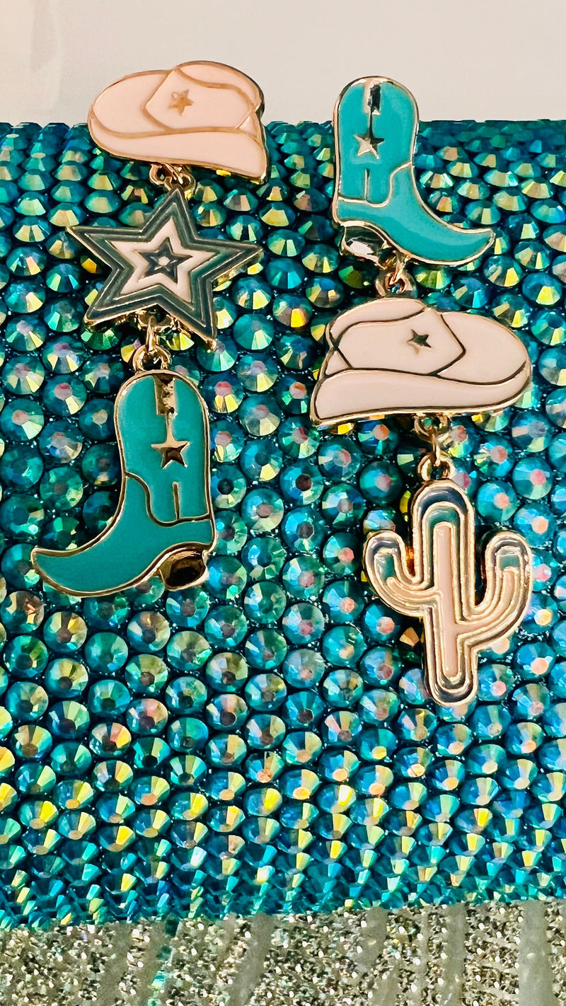 Add some southwestern flavor to your look with these eye-catching Dangling Western Turquoise Earrings. These 'statement makers' feature an eclectic mix of turquoise, white and gold drop designs in a western theme - perfect for showing off your style! Just don't forget to keep a tight grip on 'em when you're out 'ridin' the range'. Yee-haw! 2" in length