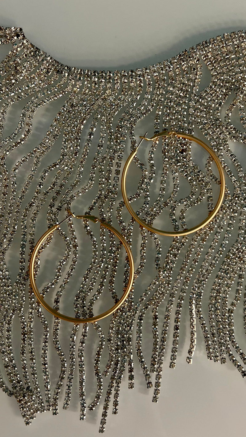 Our Cleopatra Gold Hoops earrings are sure to make a bold statement! These 50mm, gold matte hoops will give your look a sophisticated and chic vibe thanks to the timeless style of the hoop! Perfect to make any outfit pop like royalty, you'll be making heads turn with these bad boys! 1 3/4" in diameter