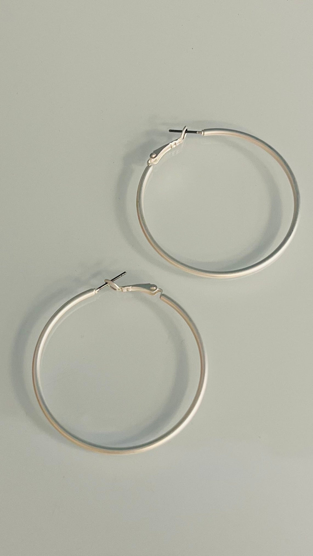 Our Cleopatra Silver Hoops earrings are sure to make a bold statement! These 50mm, silver matte hoops will give your look a sophisticated and chic vibe thanks to the timeless style of the hoop! Perfect to make any outfit pop like royalty, you'll be making heads turn with these bad boys! 1 3/4" in diameter