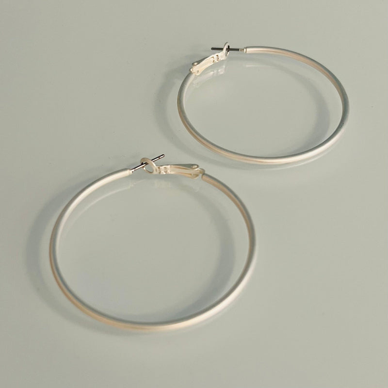 Our Cleopatra Silver Hoops earrings are sure to make a bold statement! These 50mm, silver matte hoops will give your look a sophisticated and chic vibe thanks to the timeless style of the hoop! Perfect to make any outfit pop like royalty, you'll be making heads turn with these bad boys! 1 3/4" in diameter