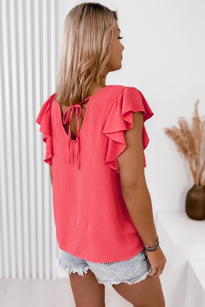 This top is a fashion classic – coral in color, stay loose and comfortable in a V-neck, ruffle sleeve, shift fit with a chic back tie design, all made from a comfy soft fabric. Look good, feel good, party on!