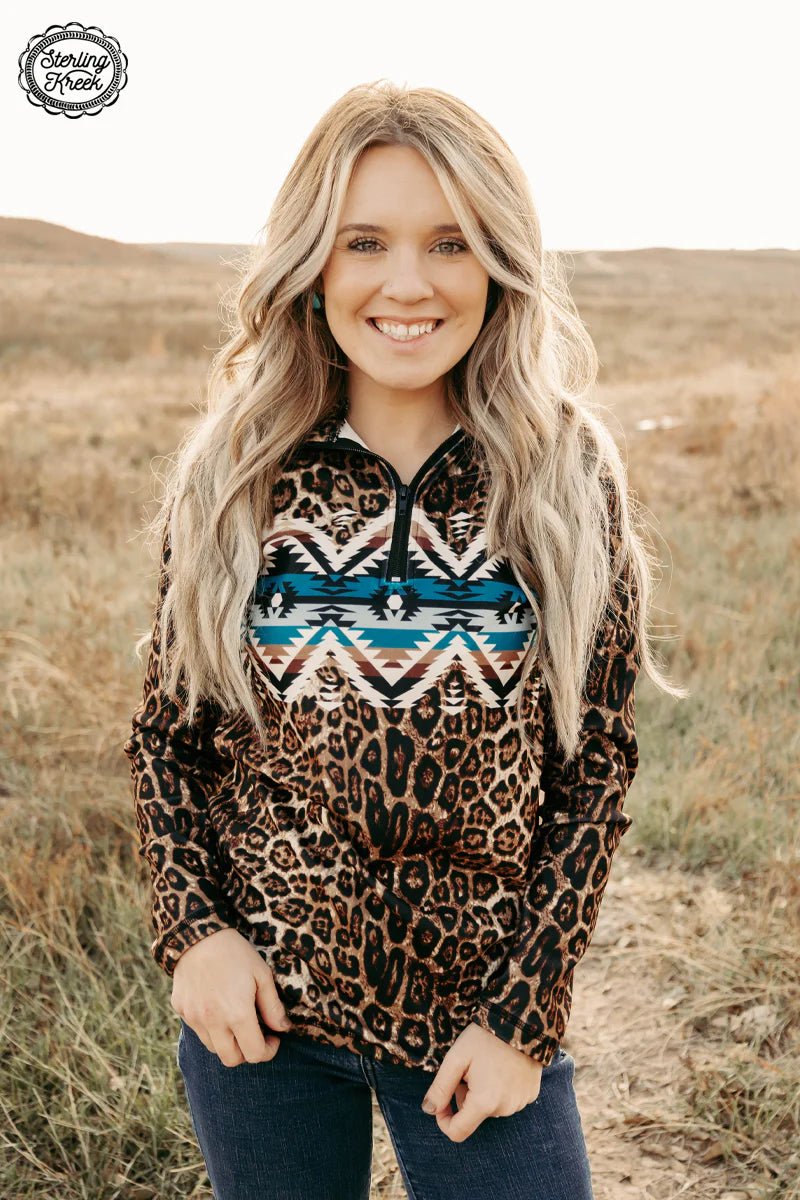 Stay cozy and stylish in our Lady In Leopard Pullover, featuring a quarter zip in a fierce leopard print! Stand out in the crowd with the bold aztec print block across the chest for a truly wild look. Stand tall and proud - you’ll be roarin’ with confidence in this on-trend pullover!  Riding Fit.  Model is wearing an XS and is 5'2"  32% Cotton, 56% Rayon, 12% Spandex