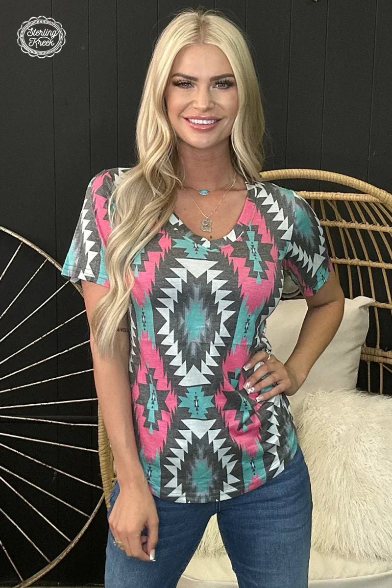 Make a statement with this fierce Montezuma Top! Boasting a sleek pink, turquoise, gray and white aztec pattern, it's sure to turn heads! Stay looking as cool as the other side of the pillow with this one-of-a-kind v-neck that rocks a faded look. Yeah, that's how you style!