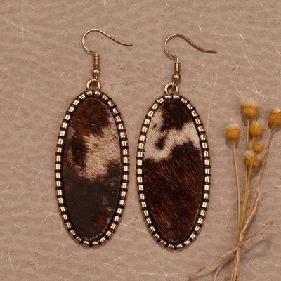 Exquisitely crafted with gold-plated metal, the Moove Oval Earrings bring luxury-style to your accessories. They feature a stunning brown hair on hide cow print, oval design, and 3" dangle to create a subtle yet sophisticated look. Be the envy of your friends, and add these earrings to your collection today.