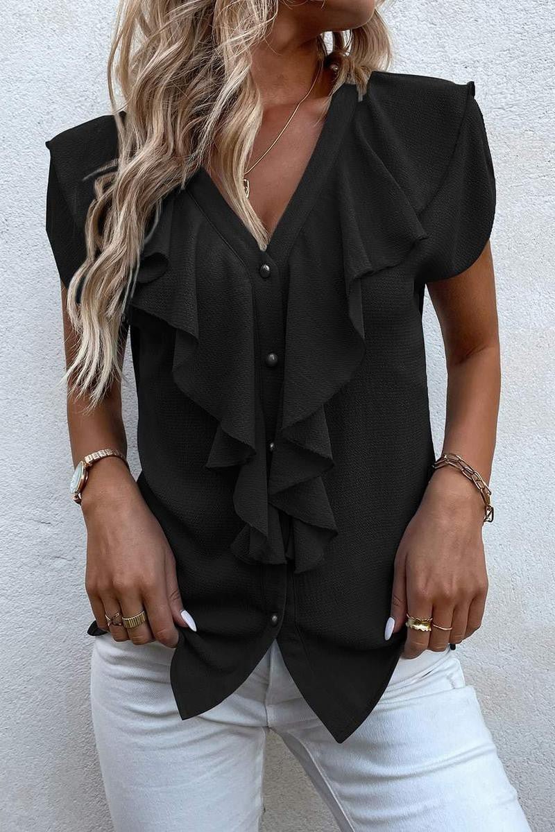 Make a statement in this contemporary Solid Ruffle Trim Blouse. Crafted from 100% Polyester, this luxe piece features a flattering V-neckline and voluminous batwing sleeves, while a button-front design is accented with ruching and a tiered ruffle trim. An elegant garment that effortlessly exudes timeless sophistication and luxury.  Sizes: S-XL