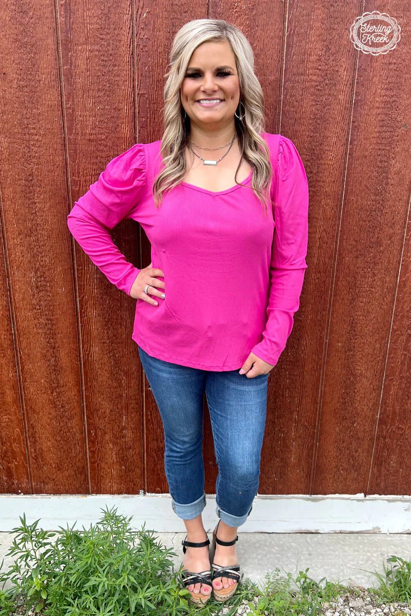 Introducing the Something Classy Pink Top! This stylish very flattering top is perfect for a night out with the girls - featuring a long sleeve ribbed fabric and trendy bubble sleeves, you'll look as chic as can be without breaking the bank. Look majestic-est and wave goodbye to boring fashion! Upgrade your wardrobe with this vibrant hot pink ribbed top with stylish bubble sleeves! It's sure to add a classy touch to any outfit and leave you feeling fierce! #BarbieVibes