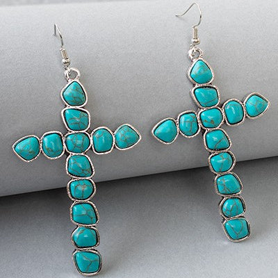 These Rolled The Stone Away Earrings are the perfect finishing touch to any outfit. Loosely draped and featuring an eye-catching cross turquoise stone, this exquisite pair of earrings is crafted from silver and detailed with intricate patterns for a unique and luxurious look. At 3" in length, these earrings will gracefully dangle from the ear with each step, providing a sophisticated edge to any ensemble.
