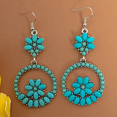 Our Squash Blossom Garden Earrings bring a touch of the Wild West to your wardrobe. These western hoop earrings feature a choice of two colors; turquoise & silver, or copper & ivory. Crafted with fish hook backs, these earrings measure 2.5" in length and will look stunning when paired with the right ensemble. Perfect for adding an elegant, tasteful sparkle to your look!