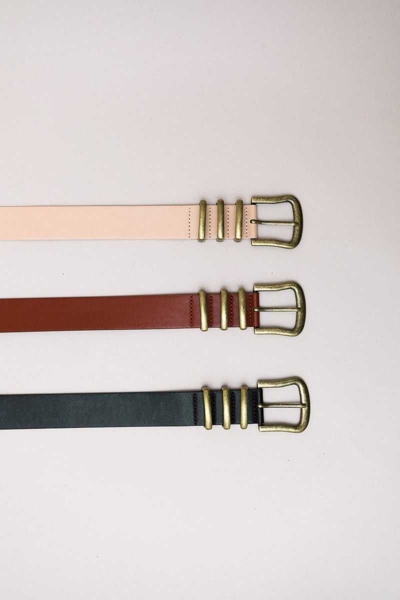 Gleaming vegan leather infuses classic style into this timeless accessory. The Three Simple Things Belt is a subtle yet refined statement piece, complementing any look. Crafted with impeccable attention to detail, this 42" X 1.5" belt offers sophistication and finesse.