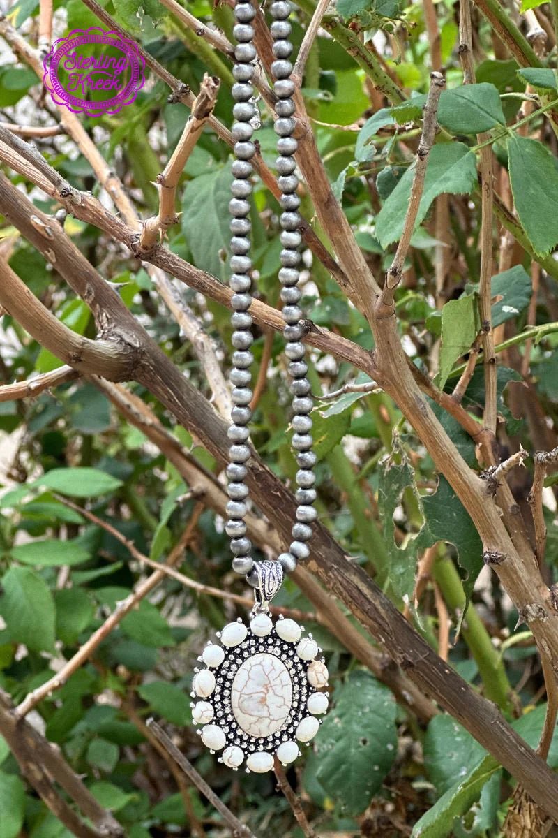 Wear your heart on your neck with this Heart of Tahiti necklace! This fun and funky piece uses a white dangle concho for a taste of the tropics as well as A Navajo pearl necklace to make sure you feel the island vibes. Strut your stuff—literally—with this unique accessory!  9.5"  ADJUSTABLE CHAIN 2.5"
