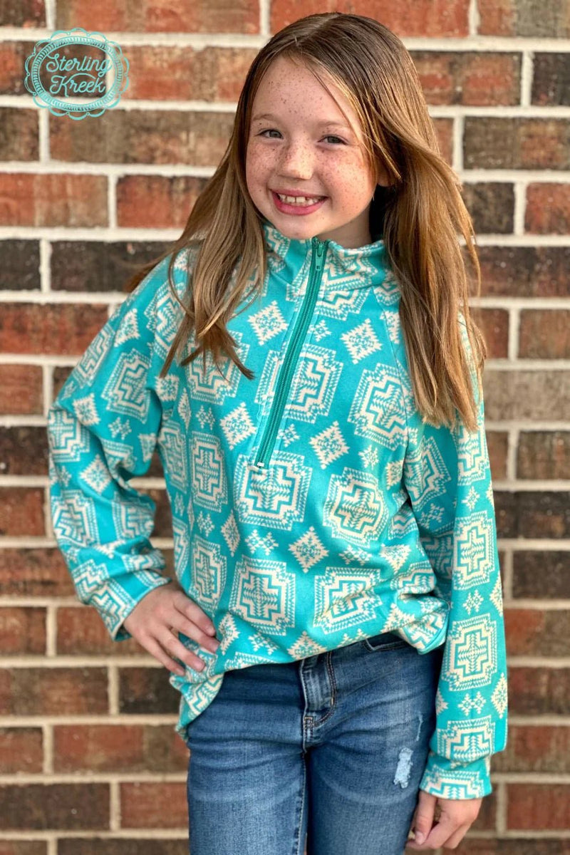 Combining classic style with southwestern flair, this Mini Down In The Canyon Pullover is sure to become your new favorite go-to! Featuring a breathtaking turquoise hue and cream aztec pattern, you'll feel like you're canyon-deep in cozy comfort! (And hey, if you can't make it to the canyon, no sweat-- this pullover will do the trick!)  Kids pullovers are 2 inches longer in the sleeves than last year.  :)  32% COTTON 56% RAYON 12% SPANDEX