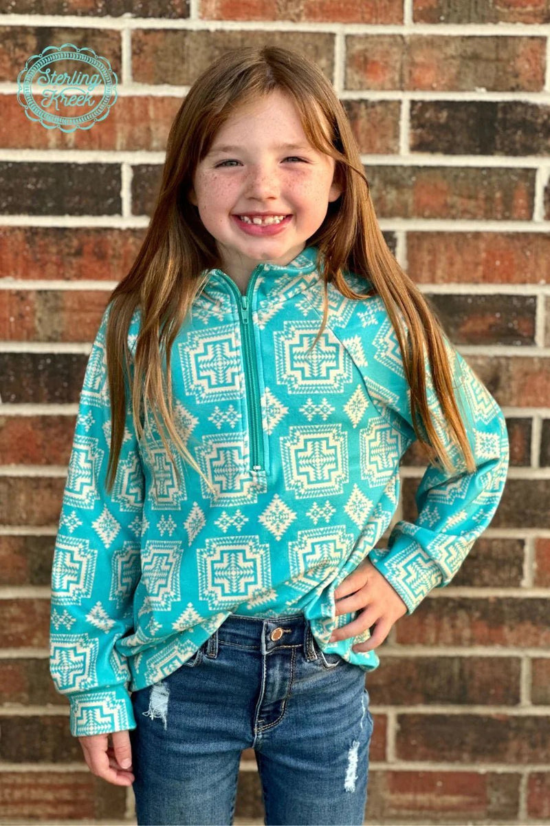 Combining classic style with southwestern flair, this Mini Down In The Canyon Pullover is sure to become your new favorite go-to! Featuring a breathtaking turquoise hue and cream aztec pattern, you'll feel like you're canyon-deep in cozy comfort! (And hey, if you can't make it to the canyon, no sweat-- this pullover will do the trick!)  Kids pullovers are 2 inches longer in the sleeves than last year.  :)  32% COTTON 56% RAYON 12% SPANDEX
