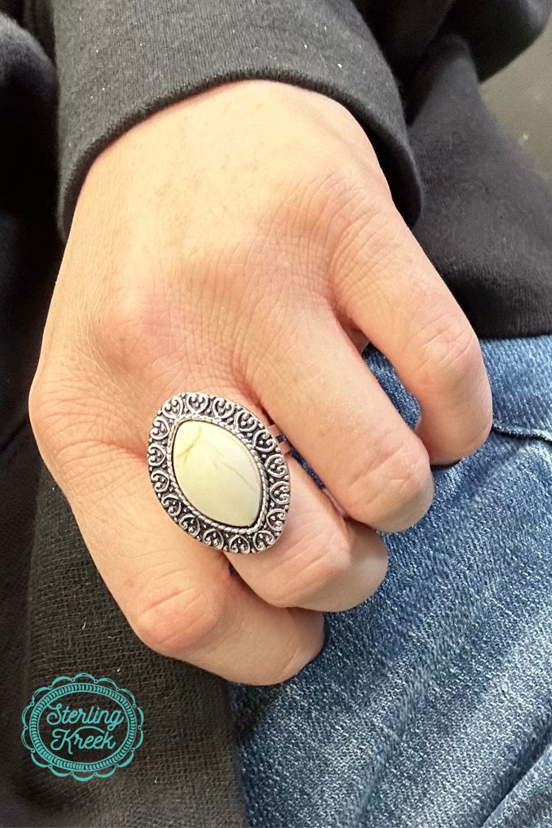 Make a statement with The Casey Ring! Featuring a white stone adjustable band engraved with delicate detail, this ring is sure to turn heads and leave a lasting impression. So get on your ring game and add a little sparkle to any ensemble. (P.S. You'll be the talk of the town!)