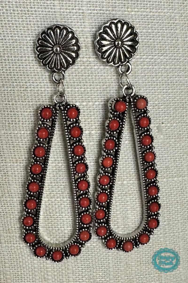 These Under The Mistletoe Earrings are the perfect festive accessory! Hanging from silver conchos with a dangle teardrop shape covered in vibrant red stones, you'll look amazing during your holiday gatherings. Add some extra cheer to your winter wardrobe with these cuties!