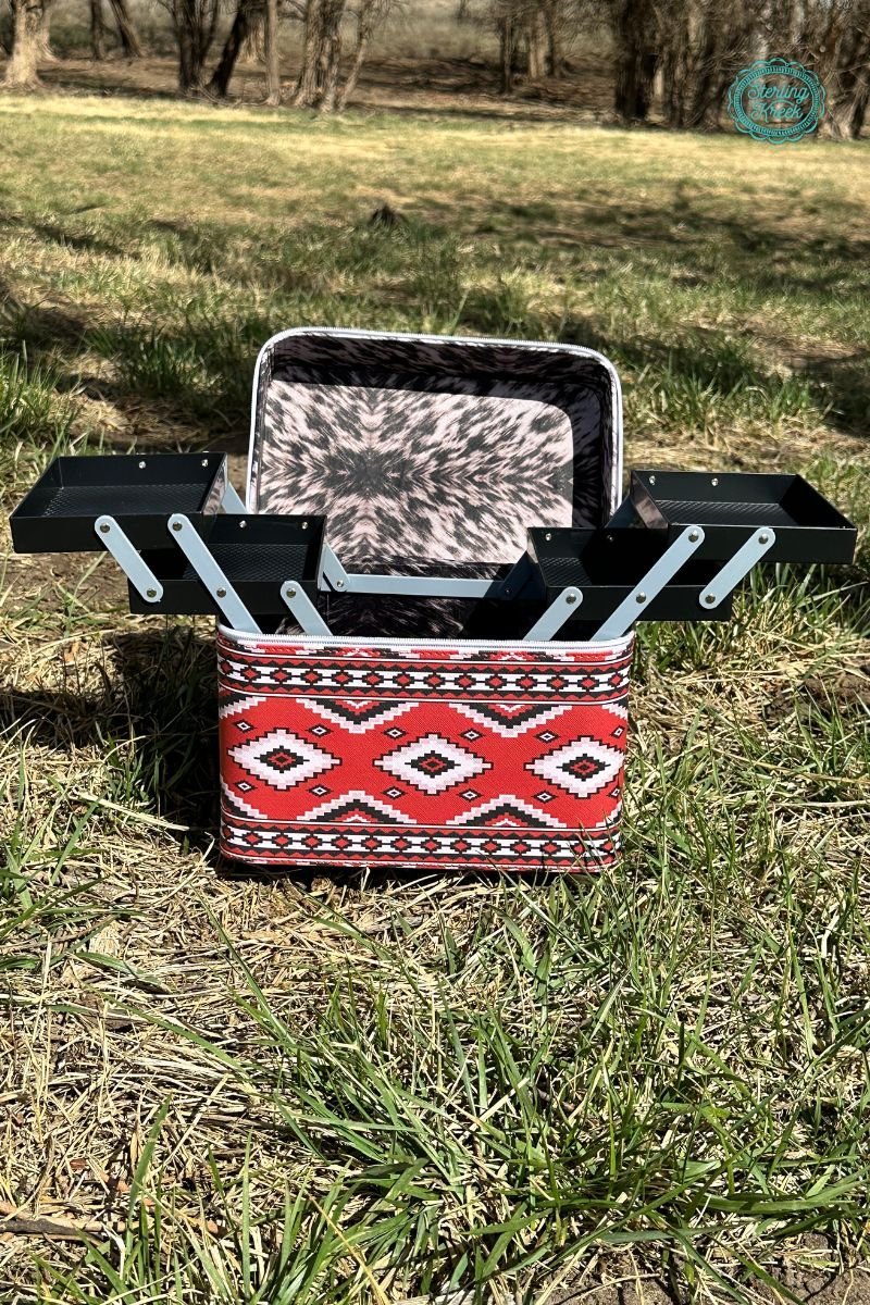 Hard make up case. Camoodle. Make up case with compartments. Make up case with handle. Zipper close make up case. Make up organizer. Make up case. Equine case. Vet bag. Ranch bag. red Aztec print carrying case. Cow Print interior. Travel case. Travel make up bag. Western style make up case. Sterling Kreek make up case. Western boutique.
