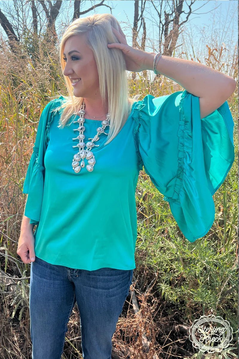 Leave your boring wardrobe in the dark and slip into this stunning INTO THE NIGHT TOP TEAL! This exquisite top is crafted from a sleek turquoise-hued fabric and features flouncy wide sleeves. And forget about fashion faux pas 'cuz this beauty will leave you looking oh-so-fine!  100% POLYESTER