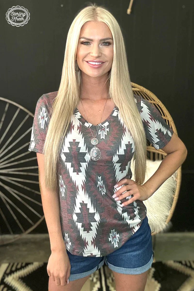 Explore endless style possibilities with the Aztec Kingdom Top! This unique top features a bold deep red, brown, and white aztec print that pairs perfectly with jeans, shorts, and skirts alike. A must-have for adding a splash of color and fun to your wardrobe! 