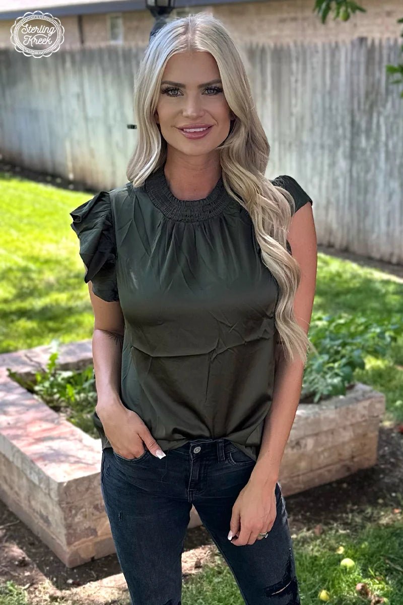 This babydoll top is not just any hunter green, it's HUNTER green! So stand out and be ready to "bag" all the compliments! Slip into this silky-smooth short sleeve top and be the life of the party! *Pairs well with our Champagne City fringe Jacket.  100% polyester 