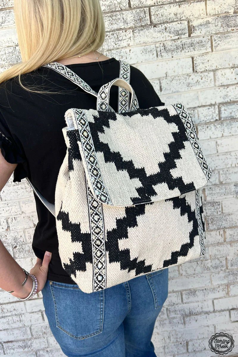 Make a statement in the SMOKEY MOUNTAIN RAIN Backpack! Your street style will sparkle with this black and cream backpack, featuring a stunning sequin-covered Aztec print on the sides that'll be sure to turn heads. Whether you're hitting the books or hitting the town, it's an accessory that you'll be proud to rock!  14" X 13" X 6"