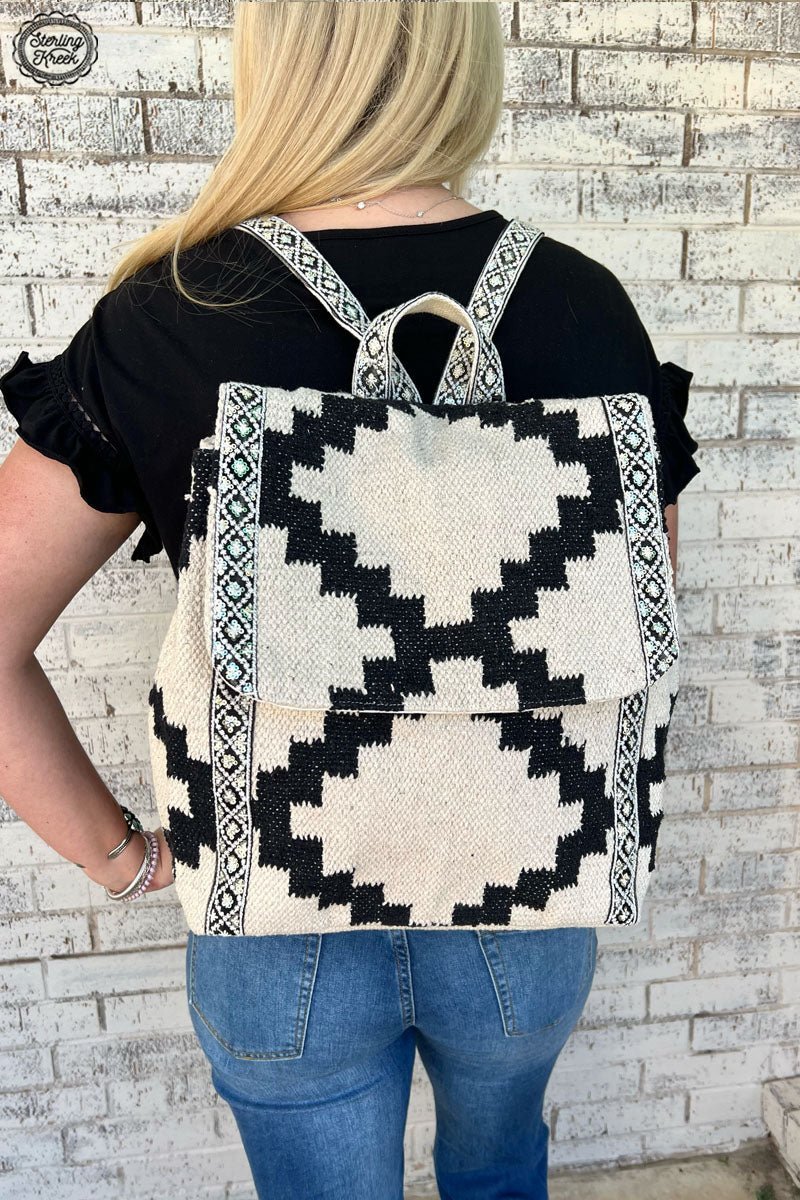Make a statement in the SMOKEY MOUNTAIN RAIN Backpack! Your street style will sparkle with this black and cream backpack, featuring a stunning sequin-covered Aztec print on the sides that'll be sure to turn heads. Whether you're hitting the books or hitting the town, it's an accessory that you'll be proud to rock!  14" X 13" X 6"