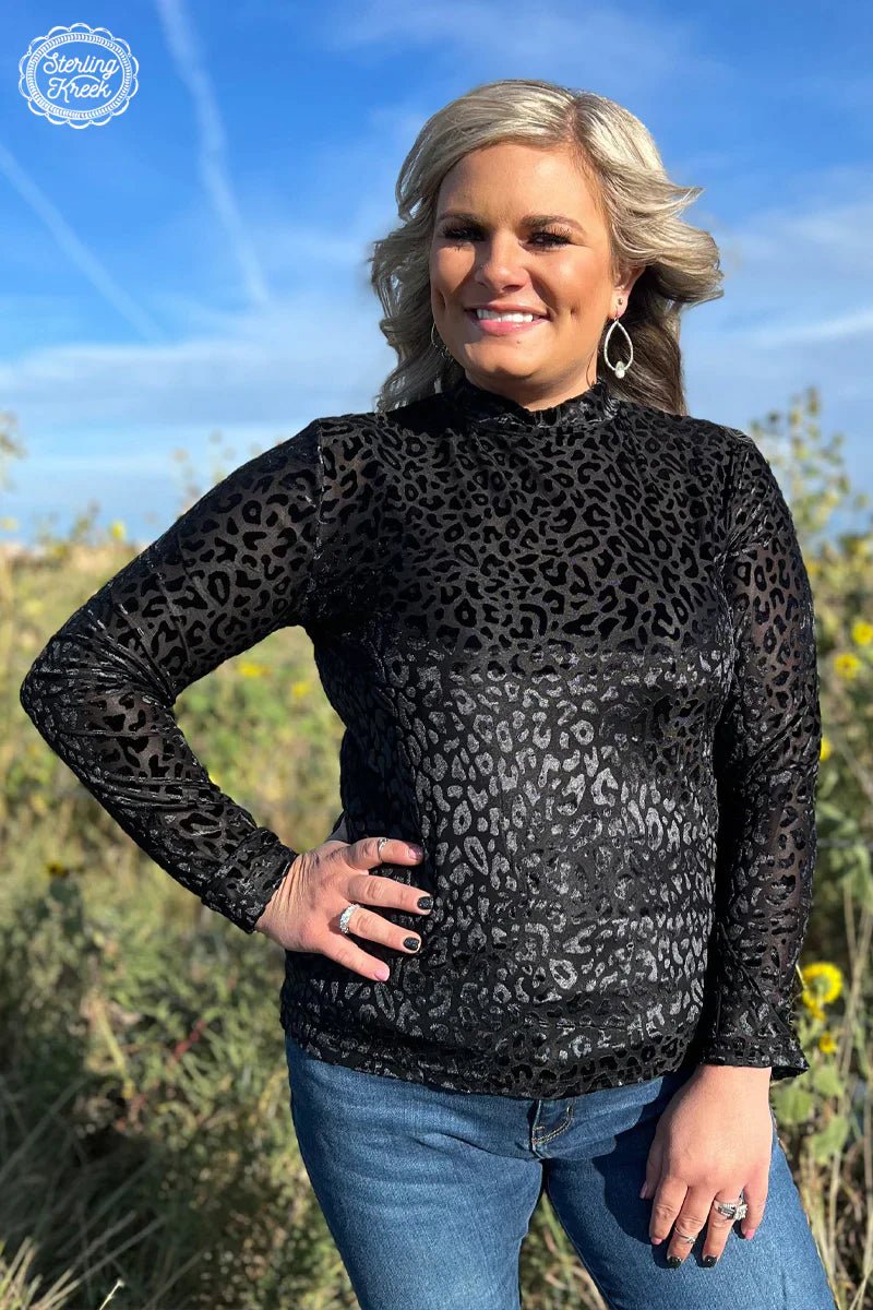 Unleash your wild side in the Midnight Panther Top! This black mesh top features a velvet leopard design for a fierce and fun look you'll love. So go ahead, take a walk on the wilder side!  96% POLYESTER 4% SPANDEX