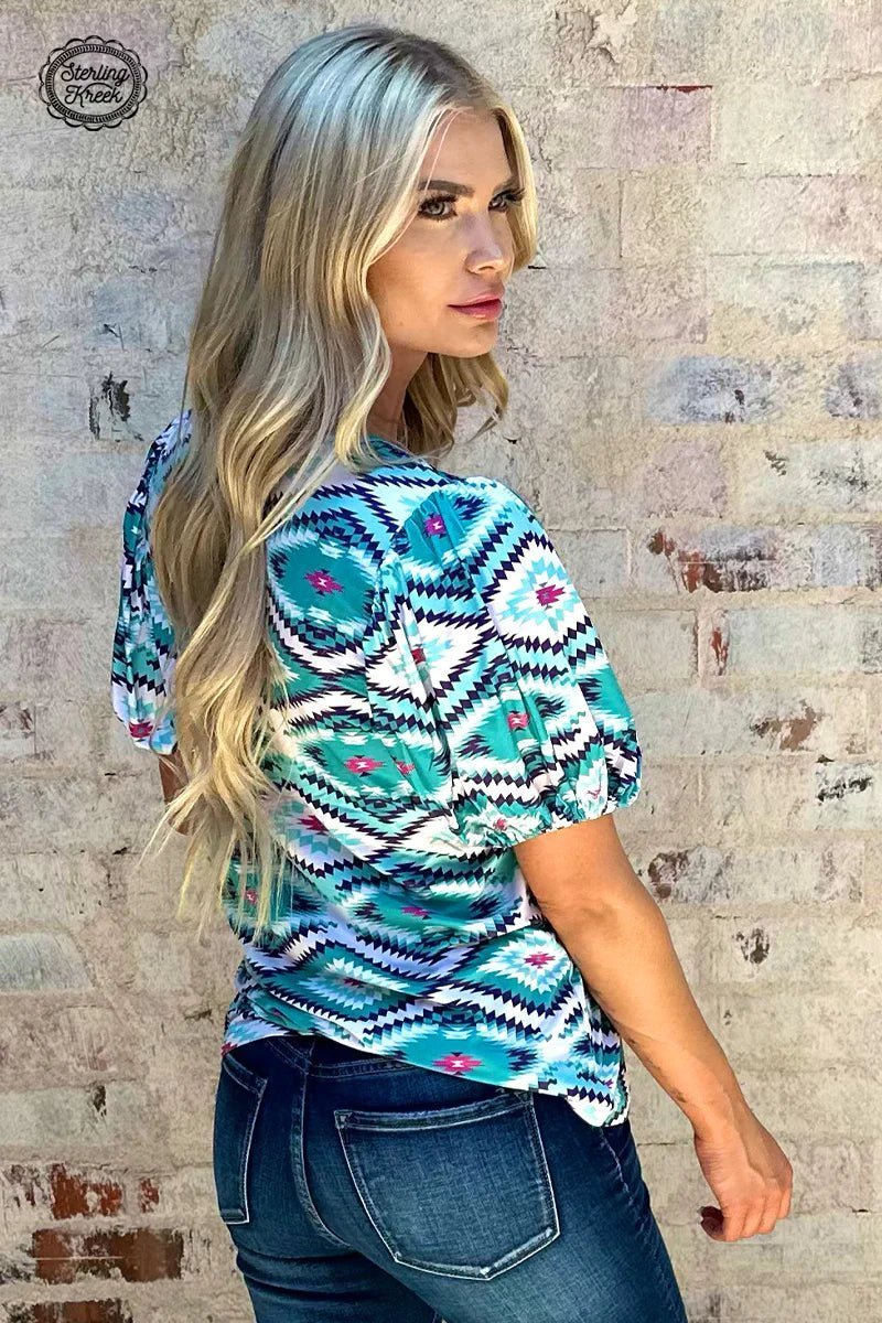 Introducing the Island Vibes Top - a one-of-a-kind statement piece that'll put you at the center of attention! This trend-setting top combines blue and turquoise shades with an eye-catching aztec pattern, finished off with a splash of pink for the perfect pop of color. Ready to look like a work of art? Get your hands on this beauty now!