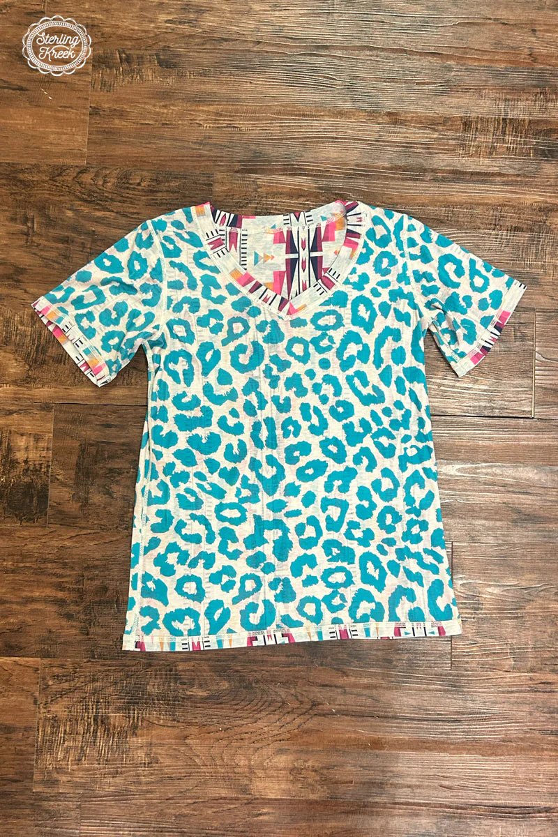 This top is the wild party animal you'll always be down for - double the fun with it's reversible v-neck, featuring a fierce turquoise leopard one side and a colorful aztec pattern on the other! We Go Together - like mac & cheese! 🧀  50% Polyester, 45% Cotton, 5% Spandex