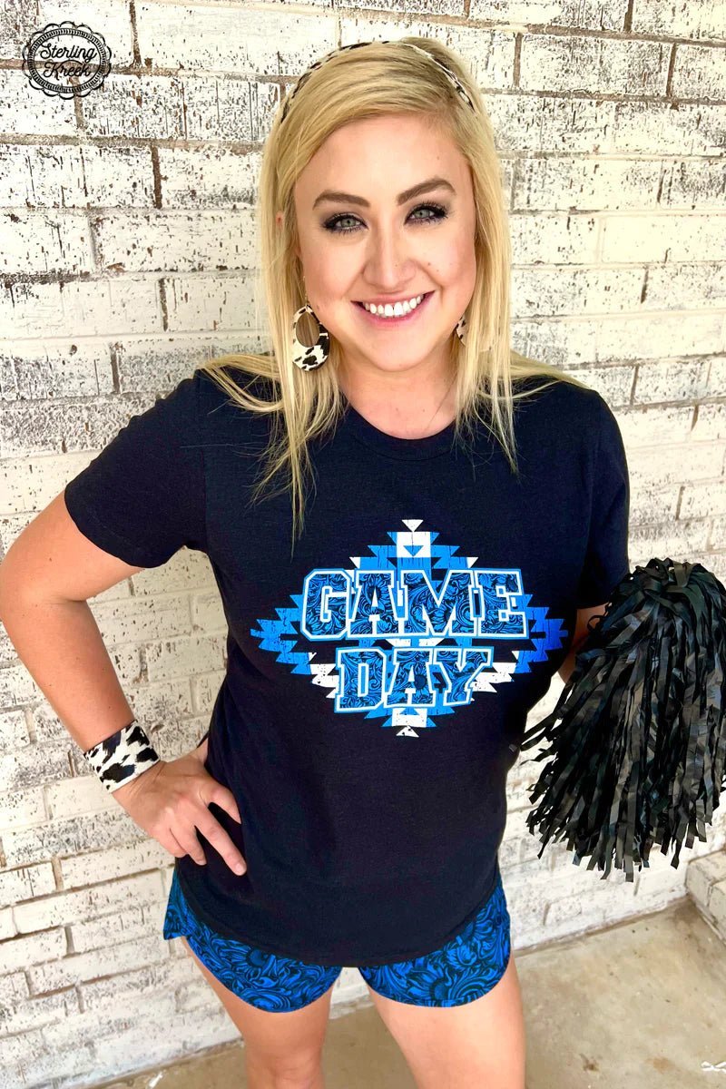 Be ready for game day with this dangerously stylish Game Day Ready Tee! It features a bright blue and white aztec design on a sleek black background that will bring your casual fit to the next level! Go from couch potato to MVP, all in one comfy tee!