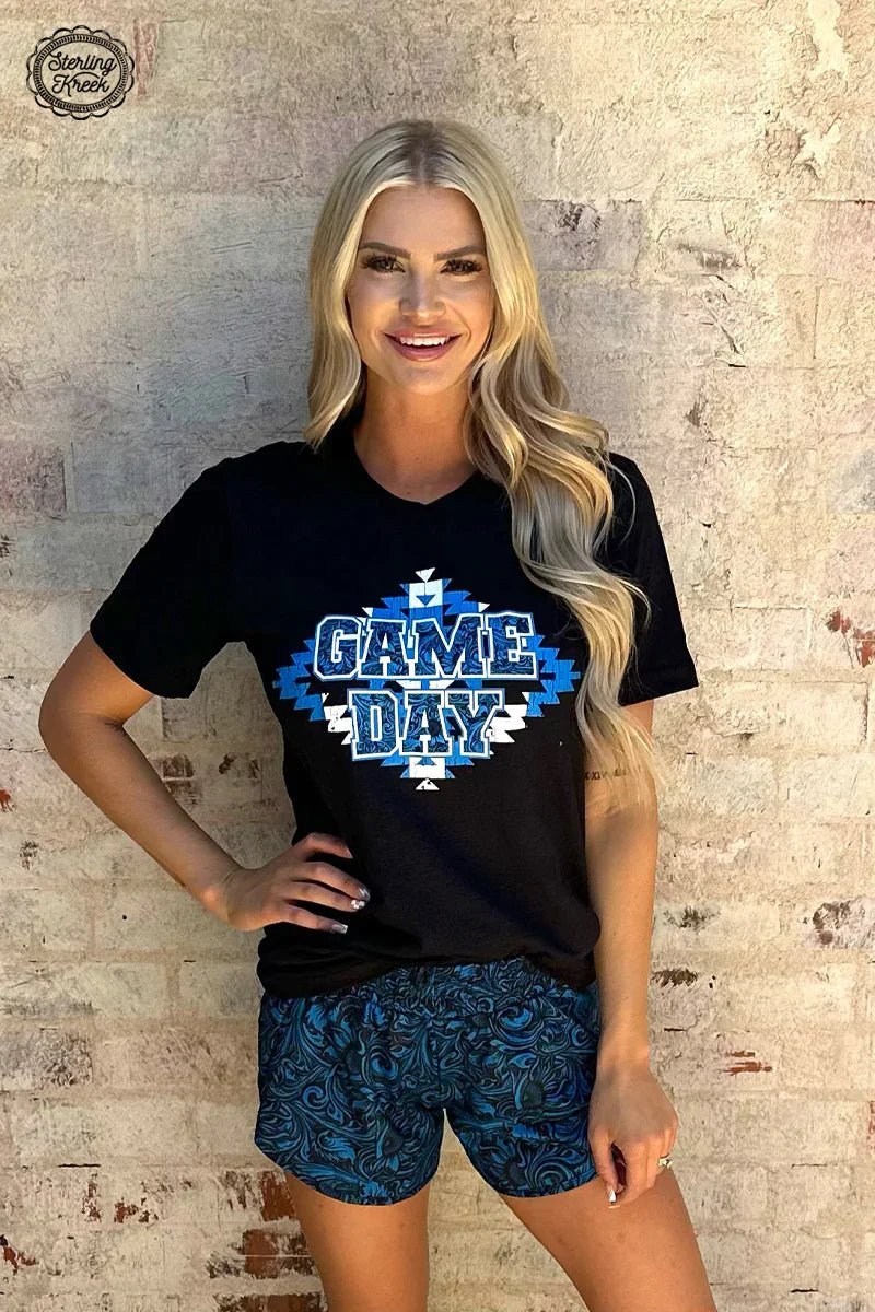 Be ready for game day with this dangerously stylish Game Day Ready Tee! It features a bright blue and white aztec design on a sleek black background that will bring your casual fit to the next level! Go from couch potato to MVP, all in one comfy tee!