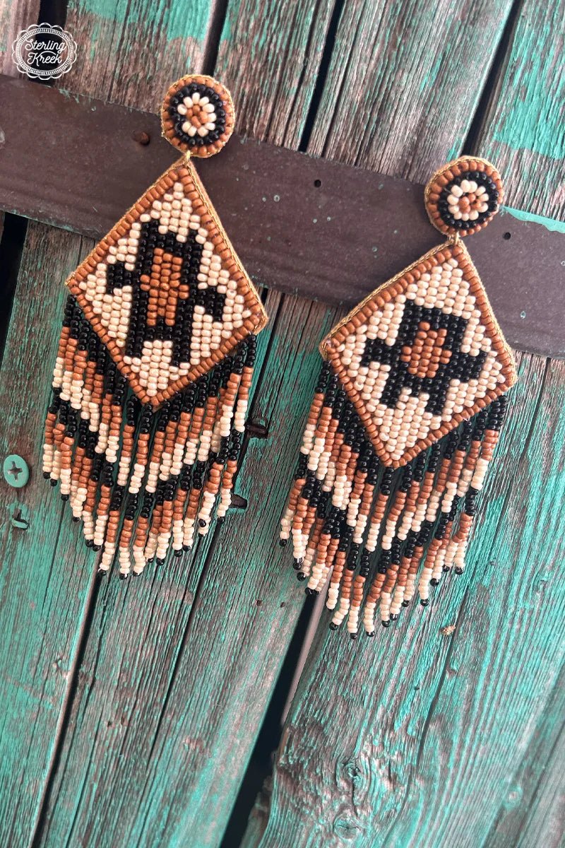 Dress up any look with The Georgia Earrings! These aztec-inspired beauties feature a colorful blend of black, orange, and cream beads that bring a fun pop of color to your style. Plus, their lightweight construction make them the perfect accessory for a long night out. Now go forth and party on, my stylish friends!