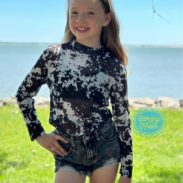 Yeehaw, y'all! Get your little one ready for the rodeo with this out-of-this-world Cow Town Top! Featuring a unique cow print on a lightweight mesh with long sleeves and a comfortable fit, this top is sure to moo-ve them to the top of the fashion herd!
