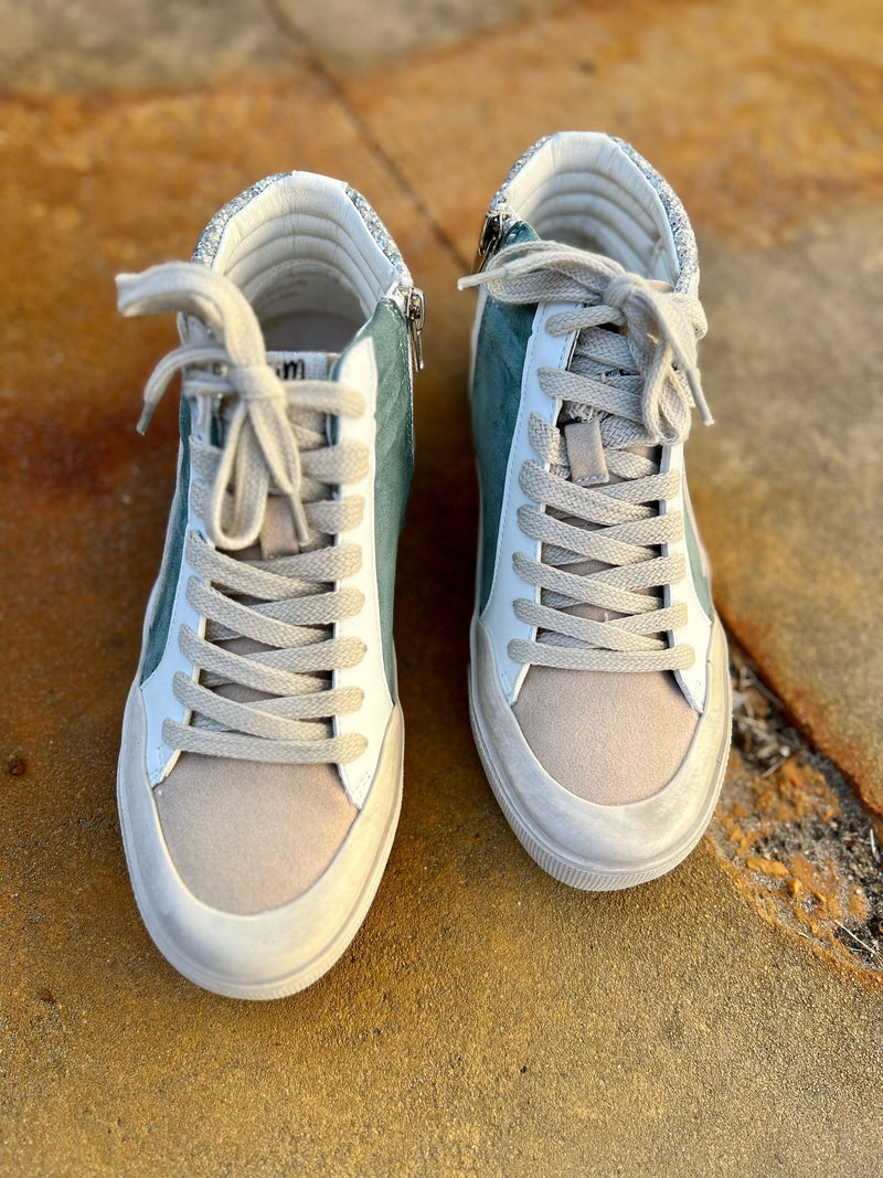 Our Wintergreen Wonderland Sneakers are the perfect blend of luxury and style. These high-tops feature a classic Oxford design in a tan suede-like material, seamlessly embellished with shimmering silver giltter and a green suede like strip on the side.  Slip into these sneakers and take your look to the next level of sophistication.  True to size.   Man made materials 
