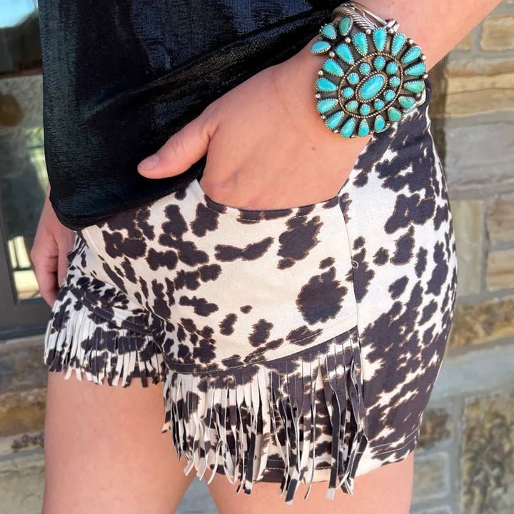 Our Bandera Chic Shorts are the perfect way to express your inner cowgirl! Crafted out of cow print suede, with a hint of fringe, these shorts will take you right back to the ranch. Wherever you may roam, you'll be totally 'moo'vin it in style!  92% POLYESTER 8% SPANDEX