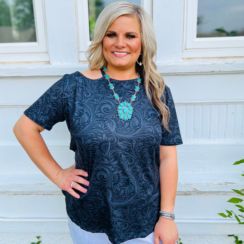Step out in style with the LIGHTS WENT OUT IN GEORGIA TOP! It's a showstopper with its black tooled leather design and oh-so-flattering shoulder cut out. Make a statement without saying a word - this top is sure to light up the room!