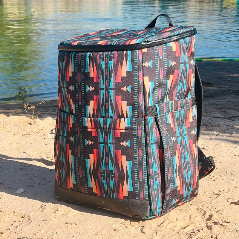 Climb to summit style with the PIKES PEAK COOLER BACKPACK! This 'cool' bag features a black base with an eye-catching orange and turquoise Aztec print - a look so fresh it'll inspire you to reach new heights! Its insulated lining will keep your drinks cold, so you can make the most of any adventure. Don't delay - rise and shine!  15X11X7.5