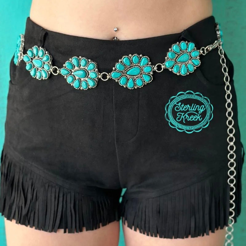 Make sure your style is as bright as a summer sky with our BLUE SKIES BELT! Featuring 11 turquoise conchos, this fashionable belt is the perfect accessory for your wardrobe — and a great way to add a bit of fun and flair to your look. So hit the town in style and show off your sunny disposition with this eye-catching belt!  LENGTH: 30"  ADJUSTABLE CHAIN: 12"