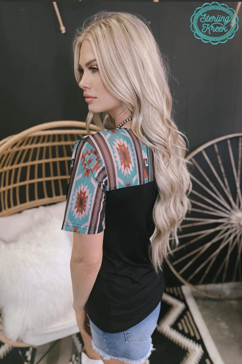This COUNTRY SQUIRE TOP is the perfect blend of style and attitude. The fun Aztec design keeps you looking hip, while the black color keeps you looking classic. Plus, you'll always be comfortable in this top – no matter what cowgirl antics you get up to!  94% modal, 6% spandex
