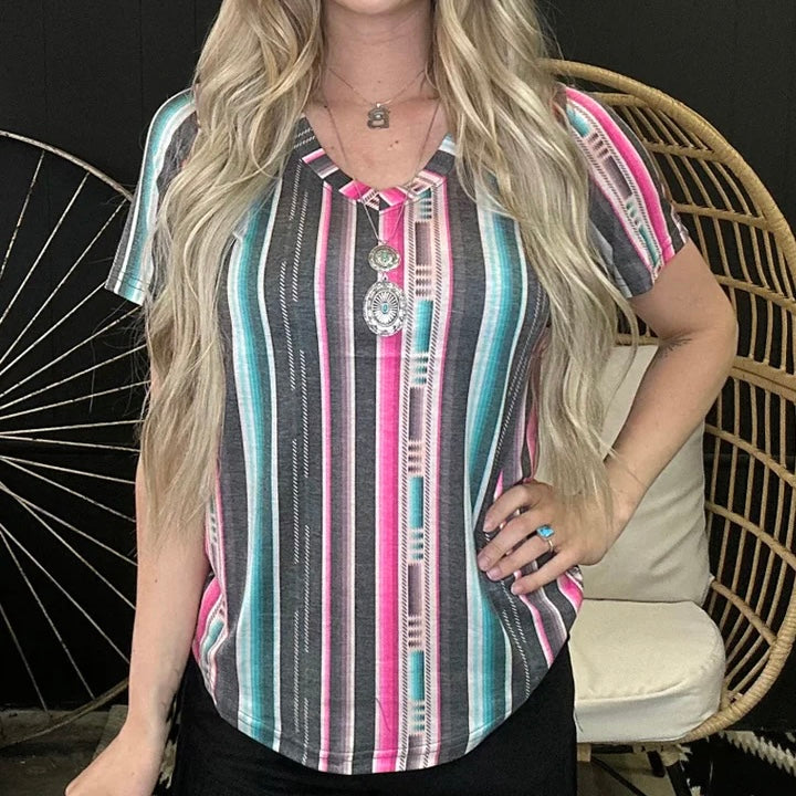 This fashionable Serape City Heart Top is guaranteed to make a bold statement! Featuring bright and vivid shades of pink, black, and turquoise, the serape v neck tee injects energy and personality into any wardrobe. Show off your unique style – and your big heart! – in this trendy top!  94% modal, 6% spandex